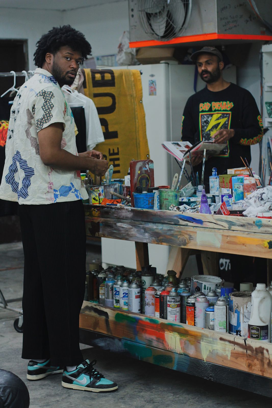AJ Girard talking with an artist at a paint cart
